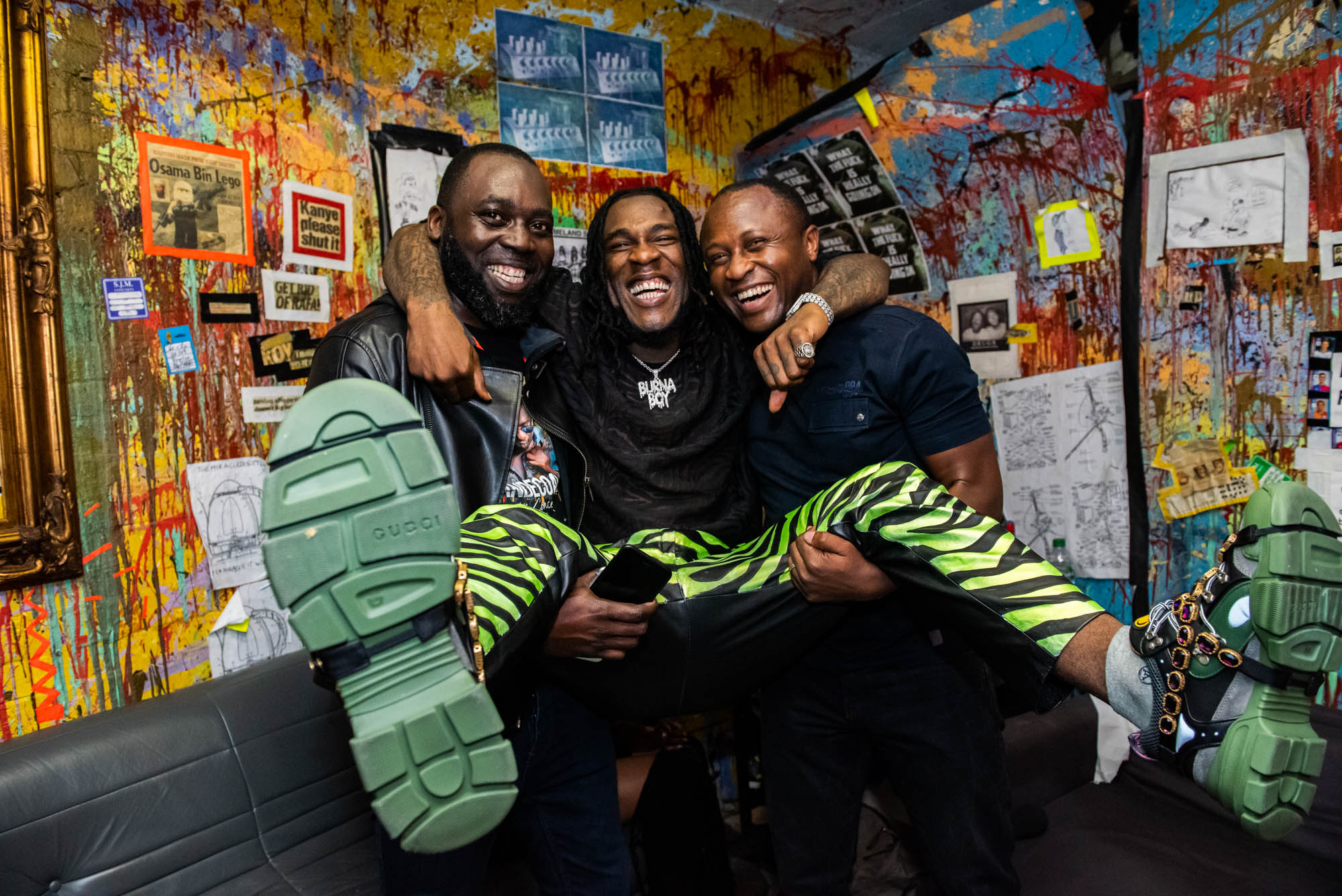 London, United Kingdom. 7th October 2018.  Backstage: Burna Boy celebrating with Tunde Phoenix and Ropo (Cokobar). Photographed by Michael Tubes